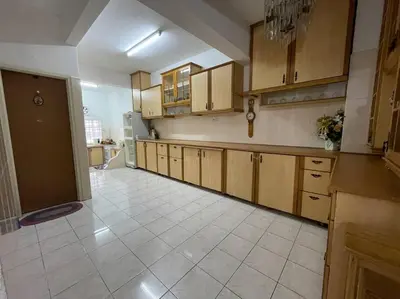 a large kitchen with wooden cabinets and a tile floor at 4BR 2Storey Terrace Homestay at Bukit Jambul by SK Vacation Homes in Bayan Lepas
