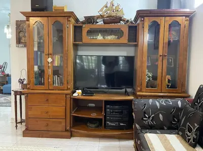 a large wooden entertainment center with a tv in it at 4BR 2Storey Terrace Homestay at Bukit Jambul by SK Vacation Homes in Bayan Lepas