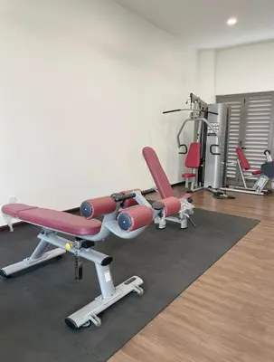 a gym with two red chairs in a room at Mizu Homestay Kea Farm 10mins to BOH in Cameron Highlands