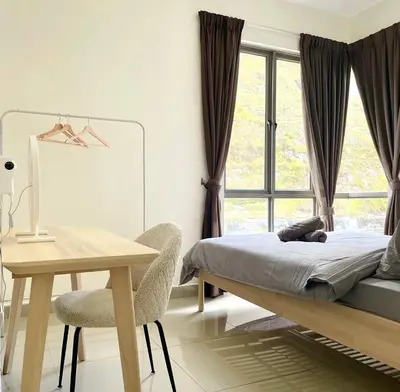 a bedroom with a bed and a desk and a window at Mizu Homestay Kea Farm 10mins to BOH in Cameron Highlands