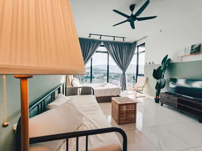 a bedroom with two beds and a ceiling fan at Beacon Executive Suites by WL in Kampong Makam