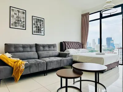 a living room with a couch and a table at Beacon Executive Suites by WL in Kampong Makam