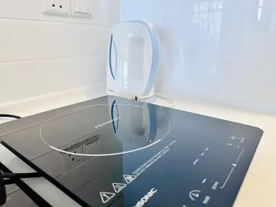 a glass table with a plate on top of it at Beacon Executive Suites by WL in Kampong Makam