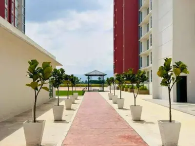 a row of potted trees inront of a building at The Anderson Haven Family Suites - Ipoh 2-bedroom Apartment in Ipoh