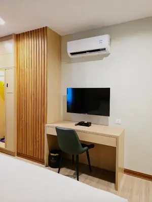 a room with a desk with a tv and a chair at Forum Hotel Penang in George Town