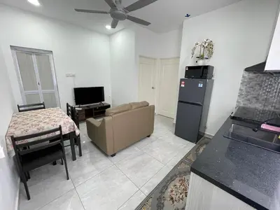 a kitchen with a couch and a table and a refrigerator at Penang Studio Homestay at Kelawai Rd, Georgetown by SK Vacation Homes in George Town