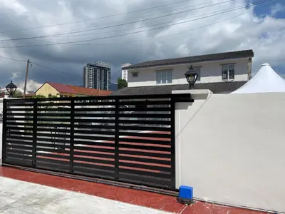 a black and white fence in front of a house at Penang Studio Homestay at Kelawai Rd, Georgetown by SK Vacation Homes in George Town