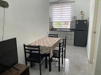 a dining room with a table and chairs and a kitchen at Penang Studio Homestay at Kelawai Rd, Georgetown by SK Vacation Homes in George Town