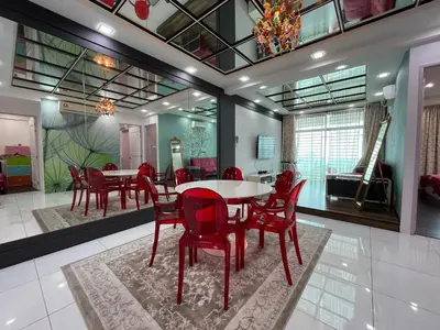 a dining room with red chairs and a table at 3BR Condo at Gelugor by Hana Suite in Jelutong