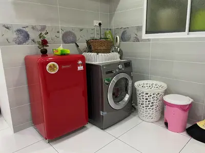 a washing machine and a washer in a kitchen at 3BR Condo at Gelugor by Hana Suite in Jelutong
