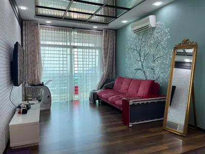 a living room with a pink couch and a mirror at 3BR Condo at Gelugor by Hana Suite in Jelutong