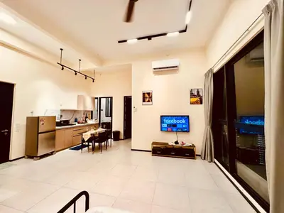 a living room with a television and a kitchen at Large Familystay 3BR Stunning Sea & City-view, Georgetown in Jelutong
