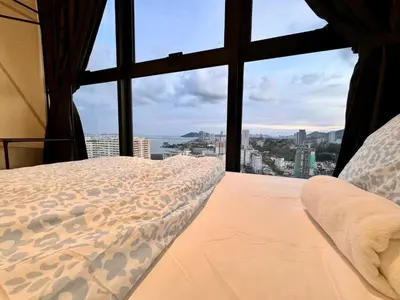 a bedroom with a bed with a view of the city at Large Familystay 3BR Stunning Sea & City-view, Georgetown in Jelutong