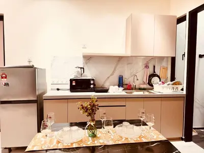 a kitchen with a table with wine glasses on it at Large Familystay 3BR Stunning Sea & City-view, Georgetown in Jelutong