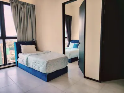a bedroom with two beds and a mirror at Large Familystay 3BR Stunning Sea & City-view, Georgetown in Jelutong