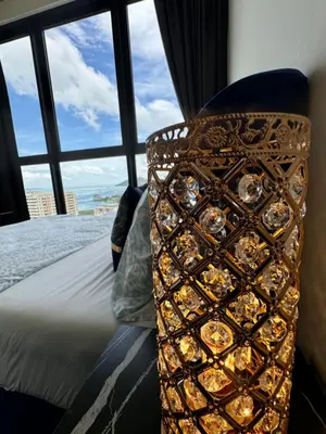 a bed in a room with a view of the ocean at Large Familystay 3BR Stunning Sea & City-view, Georgetown in Jelutong