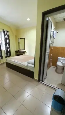 a bedroom with a bed and a bathroom with a shower at Ria Cameron Hotel in Cameron Highlands
