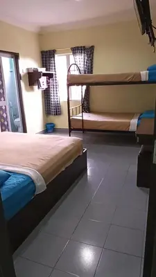 a bedroom with two bunk beds and a window at Ria Cameron Hotel in Cameron Highlands