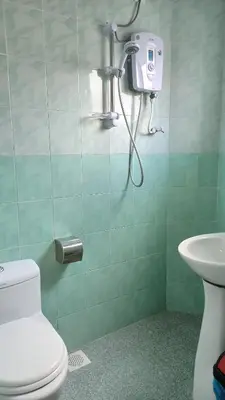 a bathroom with a shower with a toilet and a sink at Ria Cameron Hotel in Cameron Highlands