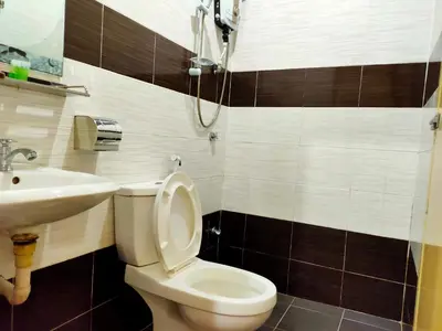 a bathroom with a toilet and a sink at Ria Cameron Hotel in Cameron Highlands