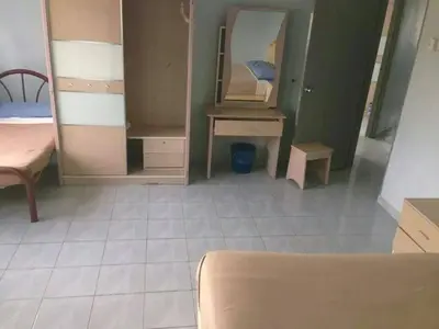 a room with a bed and a desk and a mirror at Ria Cameron Hotel in Cameron Highlands