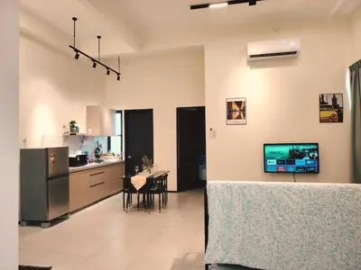 a kitchen and dining room with a table in it at Premium Familystay Urban Suites-3BR 14 pax in Jelutong