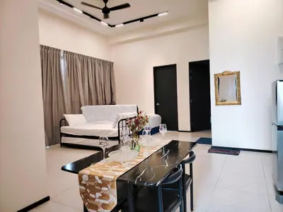 a living room with a table and a couch at world premium apartment 3BR pool sea view netflix 14pax a27 in Jelutong