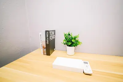 a book and a remote control on a wooden table at Swing & Pillows - 87 Chulia St, Georgetown Penang in George Town