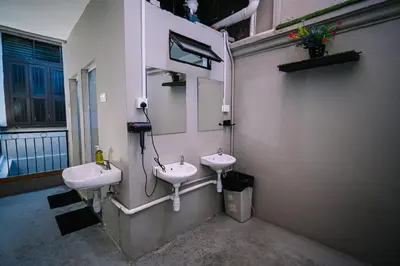 a bathroom with two sinks and a mirror at Swing & Pillows - 87 Chulia St, Georgetown Penang in George Town