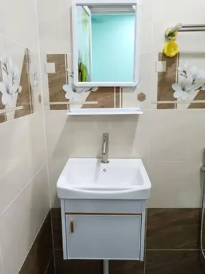 a bathroom with a white sink and a mirror at SunStar Hotel in Kampong Batu Maung