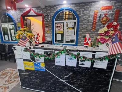 a counter with christmas decorations on it in a room at SunStar Hotel in Kampong Batu Maung