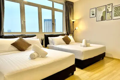 a hotel room with two beds and two windows at Georgetown Seaview 5 Min To Gurney N Straits Quay Washing Machine N Dryer in Tanjong Tokong