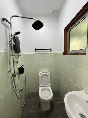 a bathroom with a toilet and a sink at Farmstay Laman Zulfaqar in Lahat