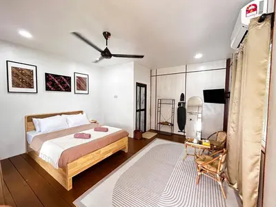a bedroom with a bed and a ceiling fan at Farmstay Laman Zulfaqar in Lahat