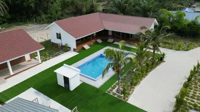 an aerial view of a house with a swimming pool at Farmstay Laman Zulfaqar in Lahat