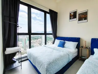 a bedroom with two beds and a large window at The Best Luxury suites Asia Spacious 3BR Sea View in Jelutong