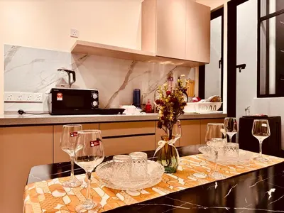 a kitchen with wine glasses on a counter at The Best Luxury suites Asia Spacious 3BR Sea View in Jelutong