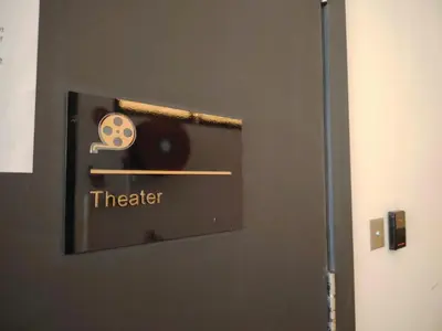 a door with a sign that says theater on it at The Best Luxury suites Asia Spacious 3BR Sea View in Jelutong