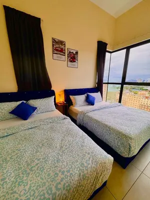 two beds in a room with a window at The Best Luxury suites Asia Spacious 3BR Sea View in Jelutong