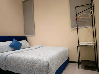 a small bedroom with a bed and a shelf at Big Family stay urban Large Pool & Sea view Netfix in Jelutong