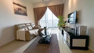 a living room with a couch and a television at Ipoh The Majestic Imperial Tower Ipoh Town Centre, 3BR Fully Air Con Homestay in Ipoh