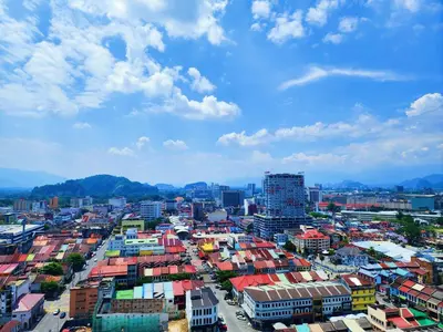 a city with colorful buildings and mountains in the background at Ipoh The Majestic Imperial Tower Ipoh Town Centre, 3BR Fully Air Con Homestay in Ipoh