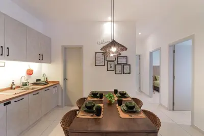 a kitchen with a wooden table in a room at Horizon Ipoh 8Pax 3R2B - Tropical Bali Retreat in Ipoh