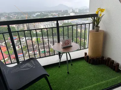 a balcony with a table with a book on it at Horizon Ipoh 8Pax 3R2B - Tropical Bali Retreat in Ipoh