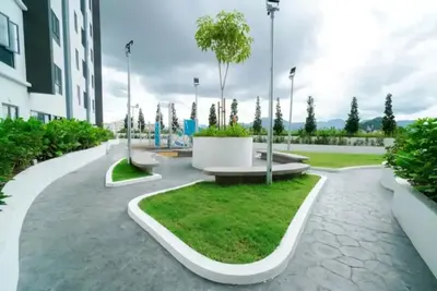 a courtyard with a bench and a tree in a building at Horizon Ipoh 8Pax 3R2B - Tropical Bali Retreat in Ipoh