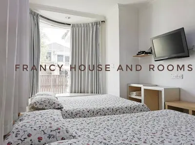 a bedroom with two beds and a flat screen tv at Castle Bungalow In Bercham Ipoh in Kampong Tasek