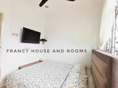 a bedroom with a bed and a tv on the wall at Castle Bungalow In Bercham Ipoh in Kampong Tasek