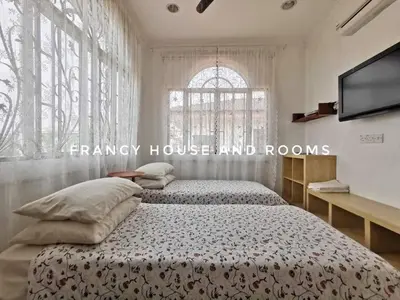 a bedroom with two beds and a large window at Castle Bungalow In Bercham Ipoh in Kampong Tasek