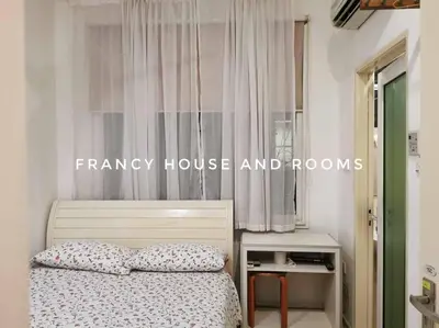 a bedroom with a bed and a window with curtains at Castle Bungalow In Bercham Ipoh in Kampong Tasek