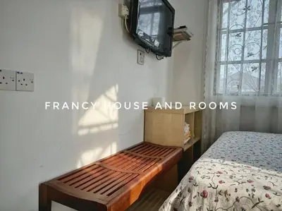 a bedroom with a bed and a tv on the wall at Castle Bungalow In Bercham Ipoh in Kampong Tasek